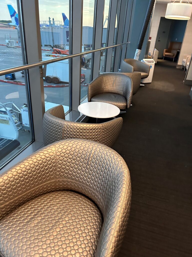 a row of chairs and a table in a room with windows