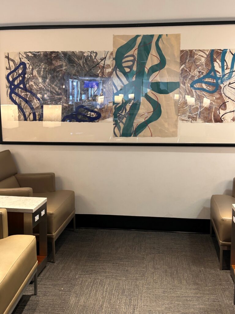 a room with chairs and art on the wall