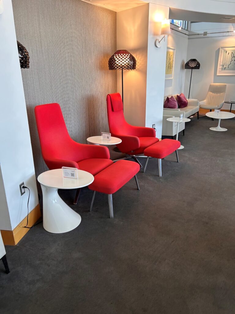 a room with red chairs and tables