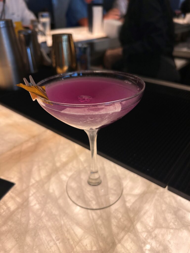 a glass with a pink liquid in it