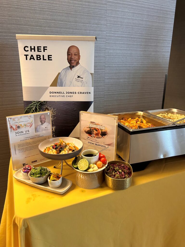 food on a table with a sign