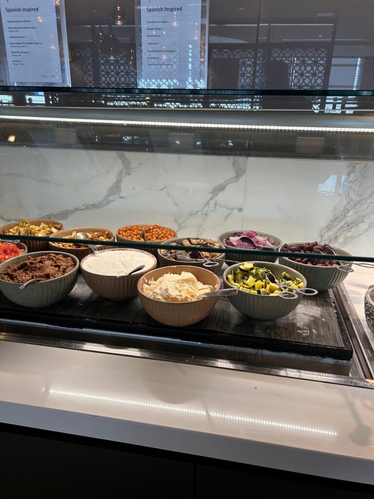 a group of bowls of food in a glass case