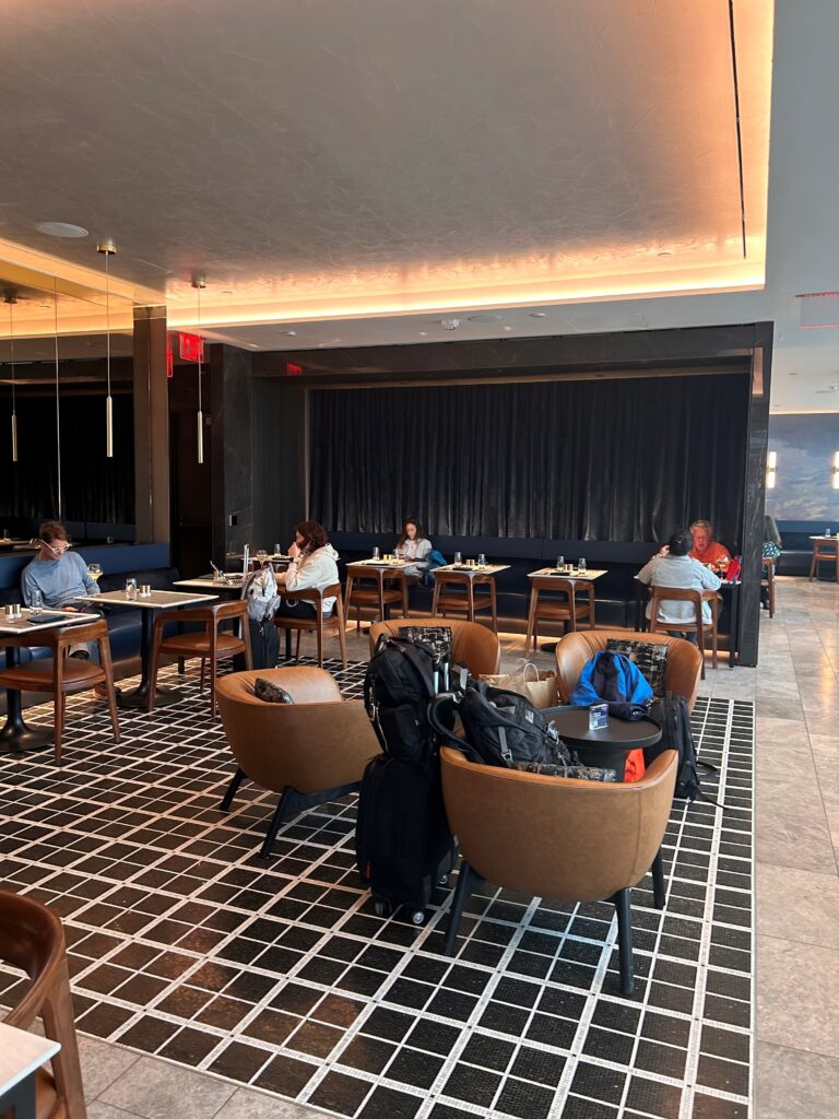 a group of people sitting at tables in a restaurant