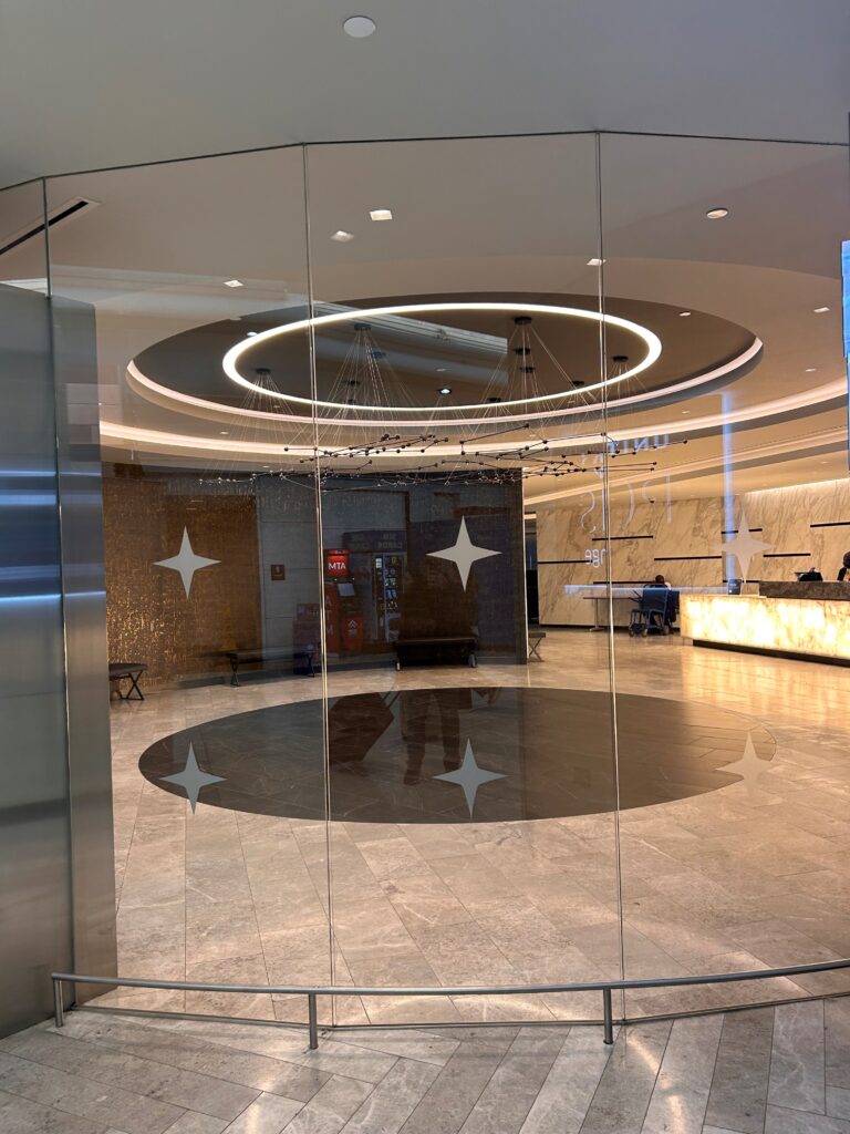 a glass door with a circular pattern on the floor