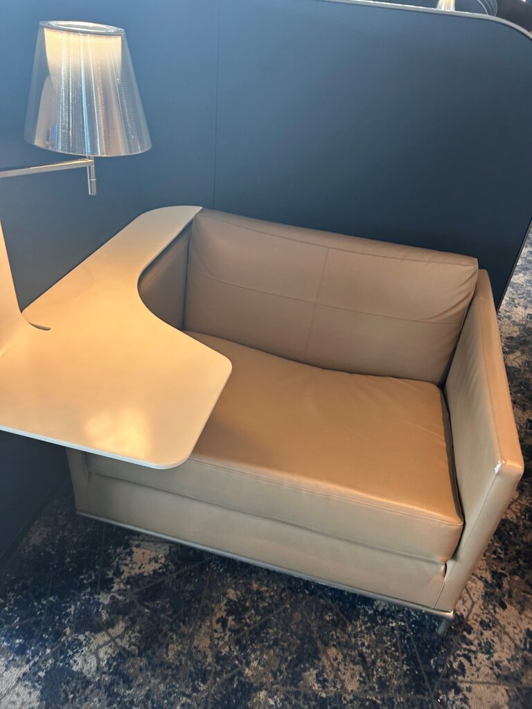 a couch with a table and lamp