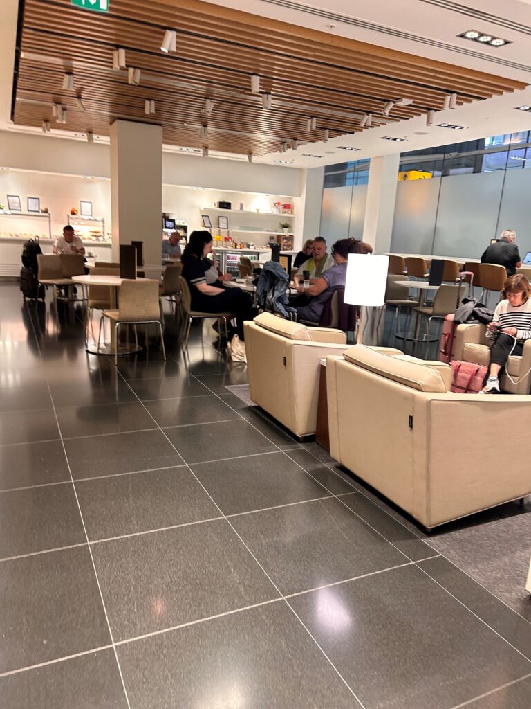 a group of people sitting at tables in a room with chairs and tables