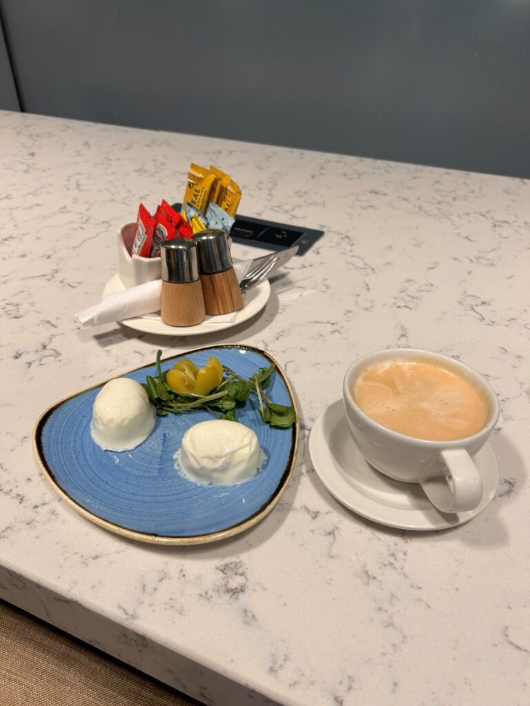 a plate of food and a cup of coffee on a table