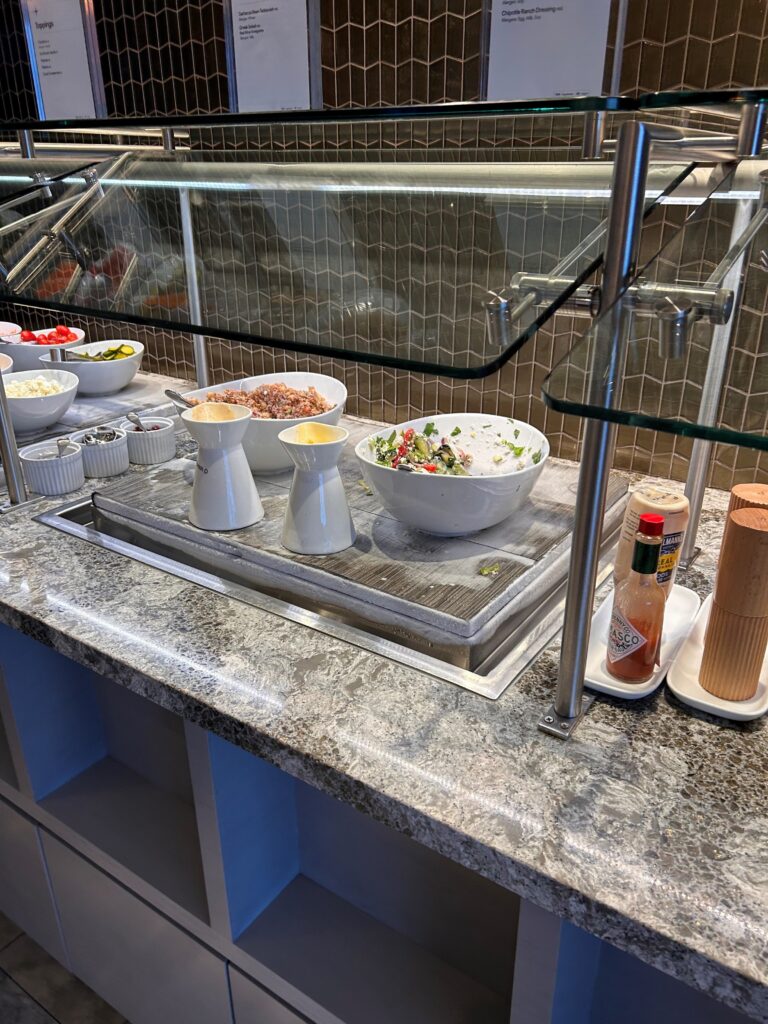 a buffet line with bowls of food