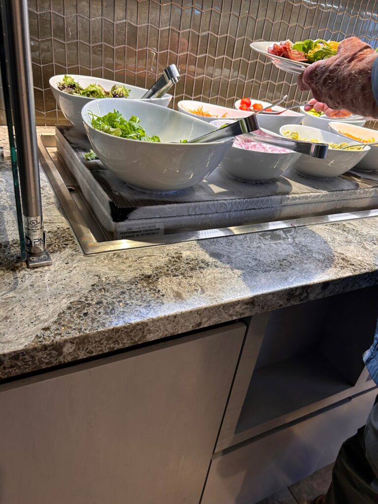 a person holding a glass of food