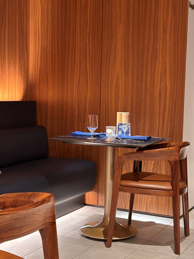 a table with wine glasses and a couch in a room