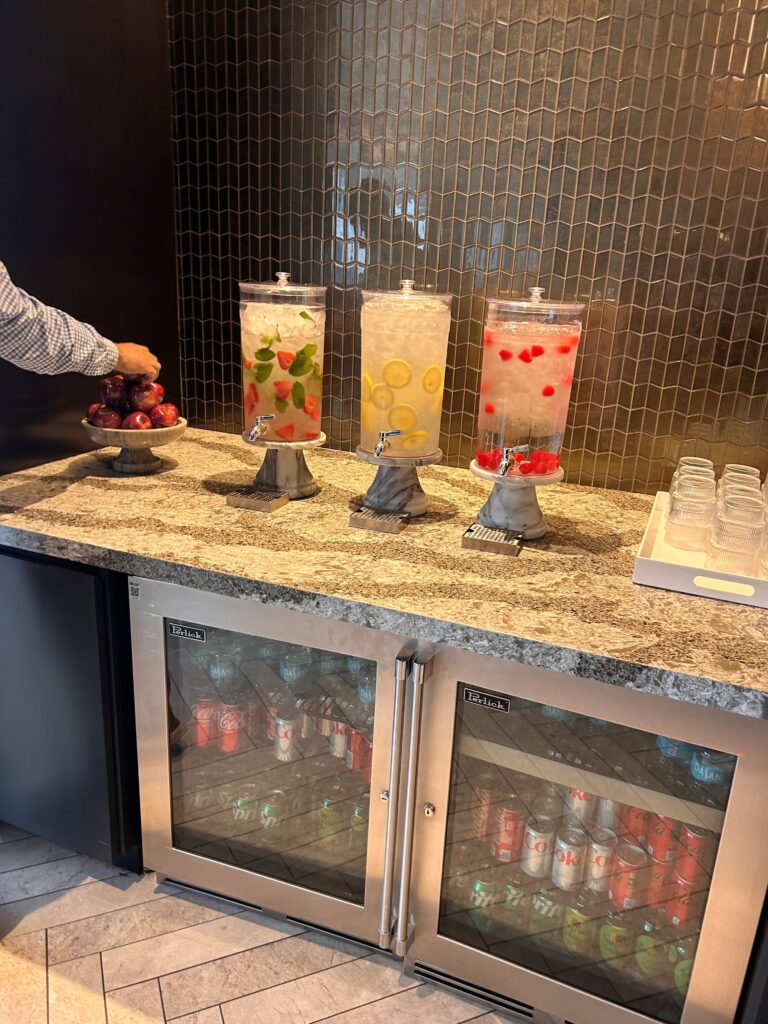 a person standing at a counter with drinks in containers