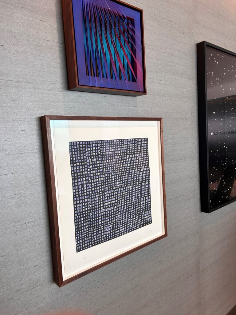 a group of framed pictures on a wall