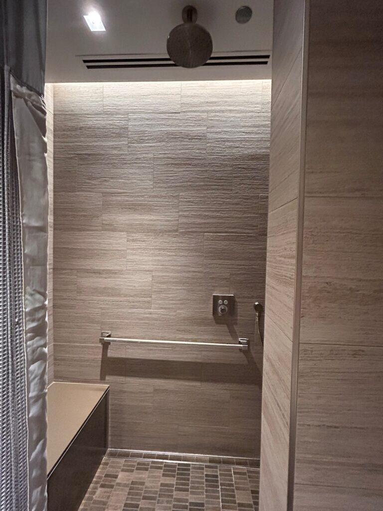 a bathroom with a shower and a towel rack