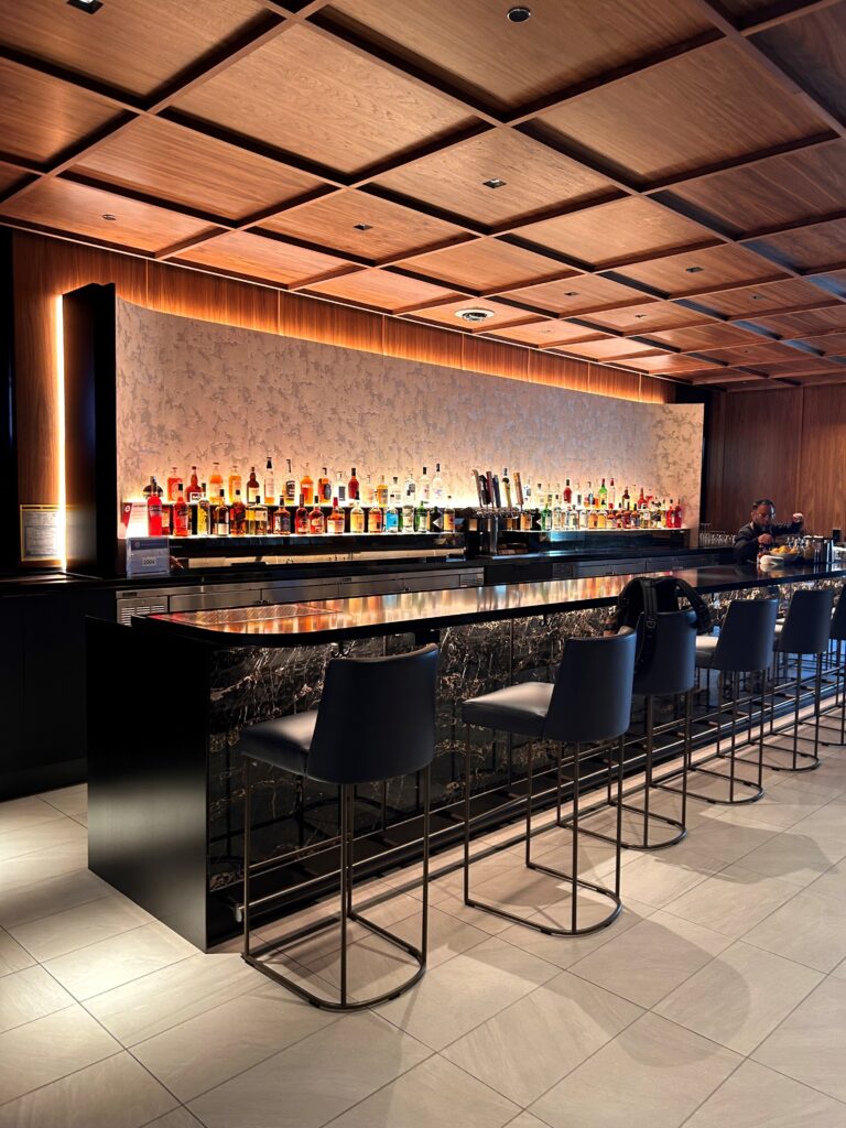 a bar with many bottles of liquor on the counter