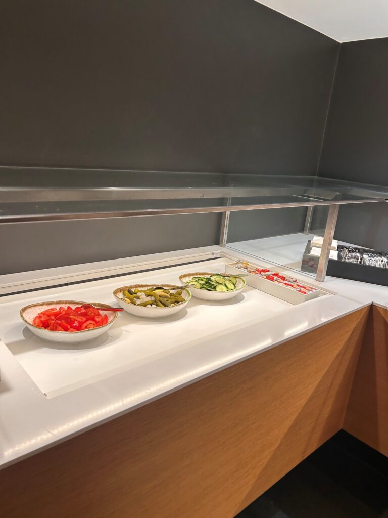 a row of bowls of food on a counter