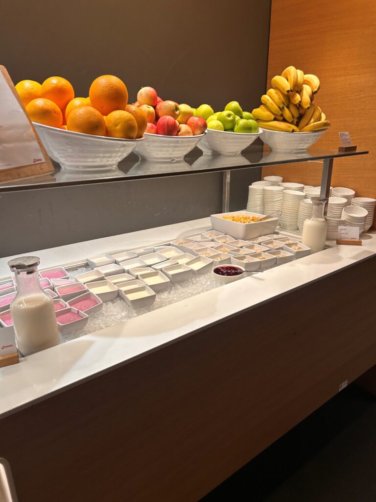 a shelf with fruit and yogurt