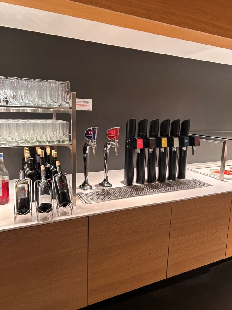 a row of wine glasses and a row of beer taps