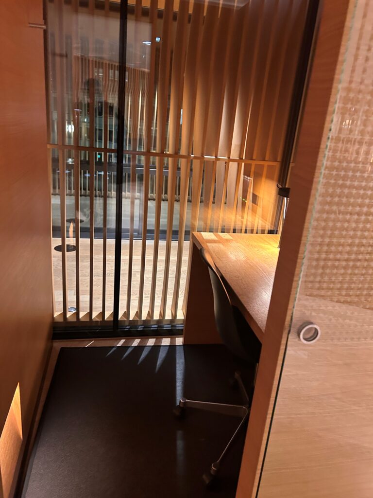 a desk and chair in a room with a window