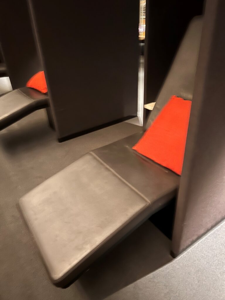 a chair with a red pillow
