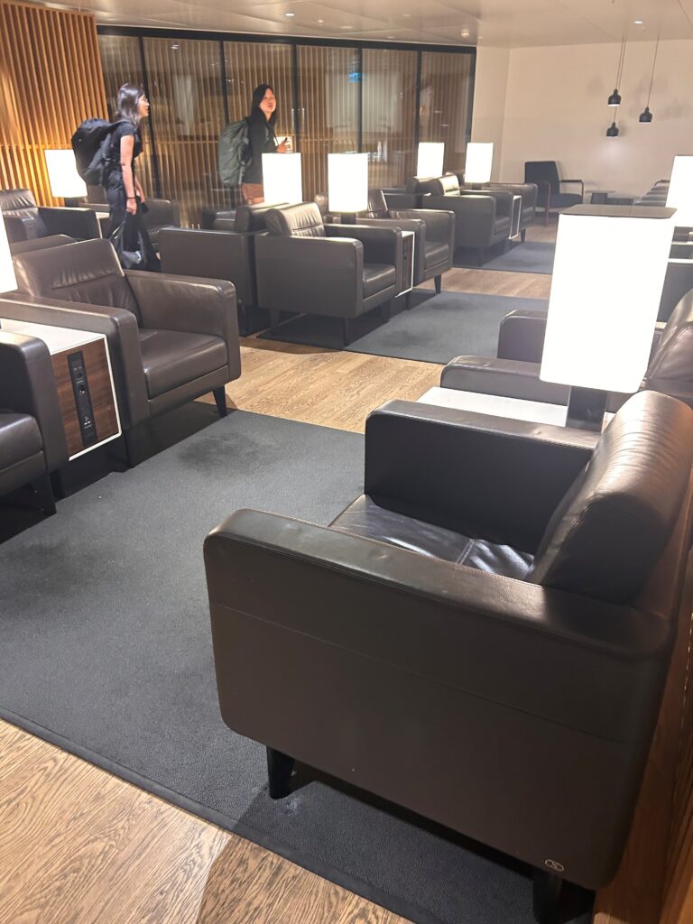 a group of people in a room with chairs and tables