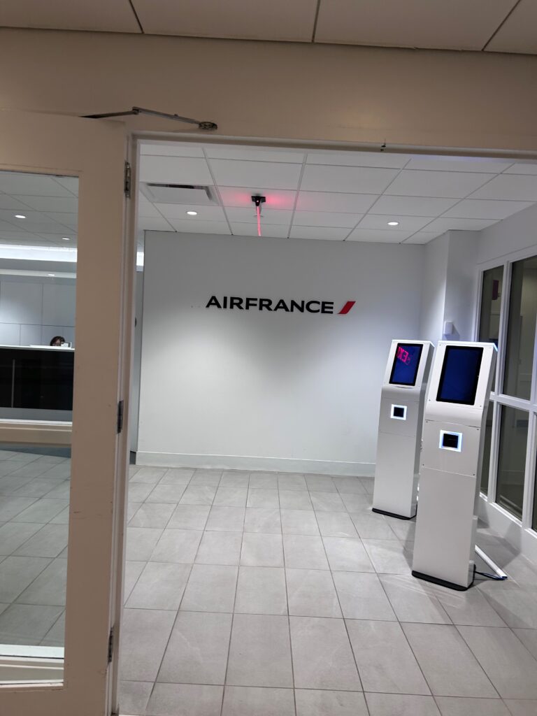 a white room with two white machines and a sign