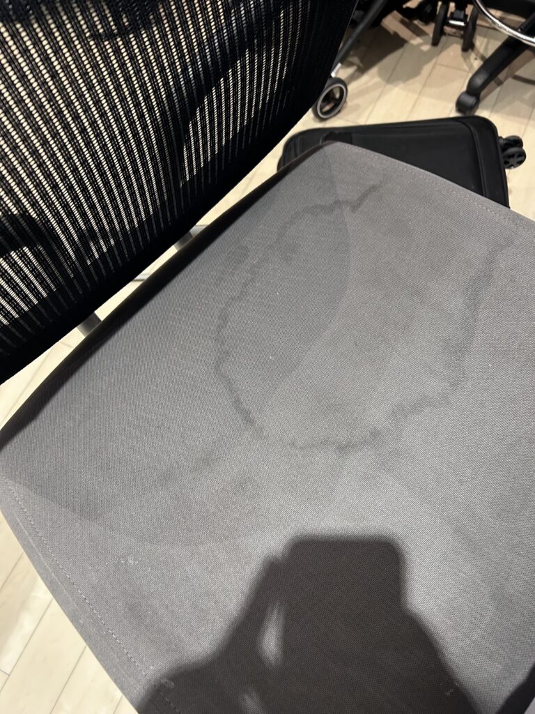 a chair with a black mesh back