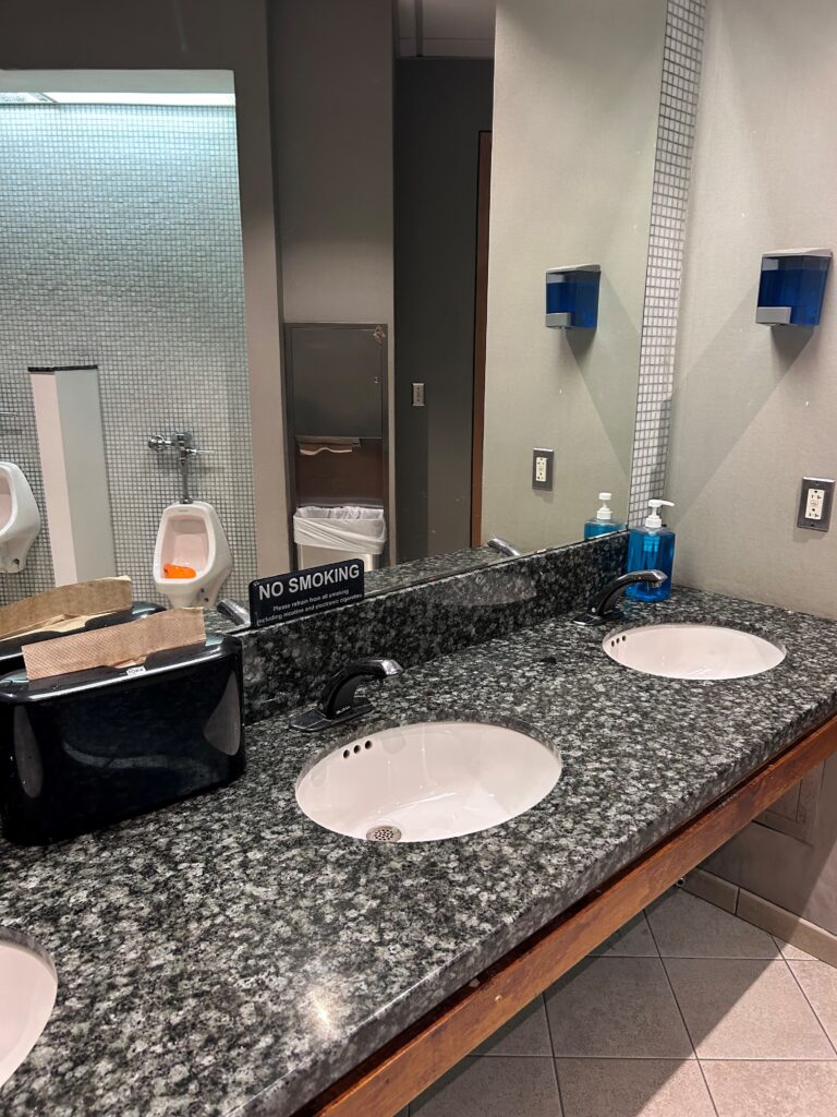 a bathroom with sinks and urinals