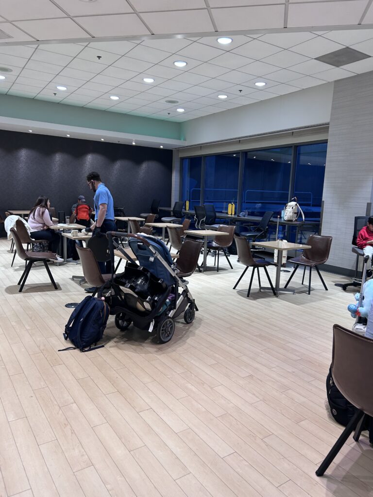 a group of people in a room with tables and chairs