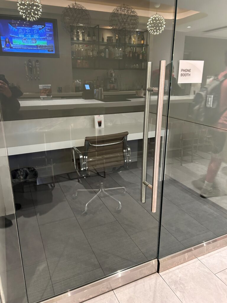a glass door with a chair and a bar