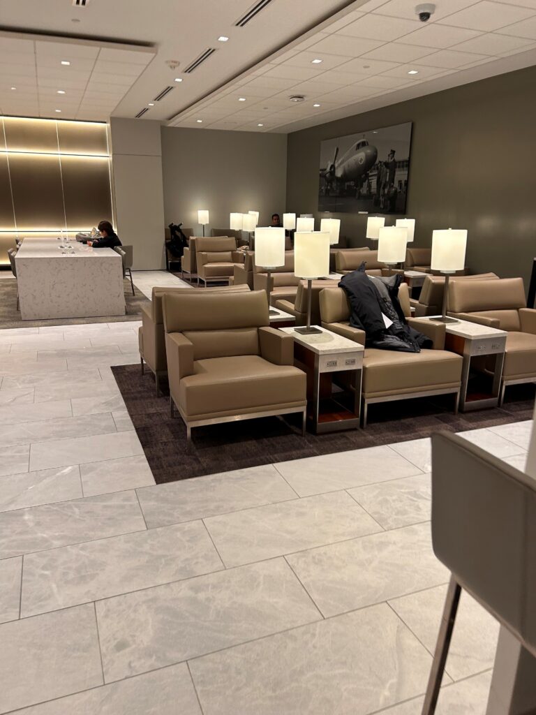 a room with chairs and a man sitting on it