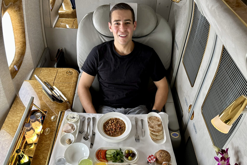a man sitting in a chair with food on it