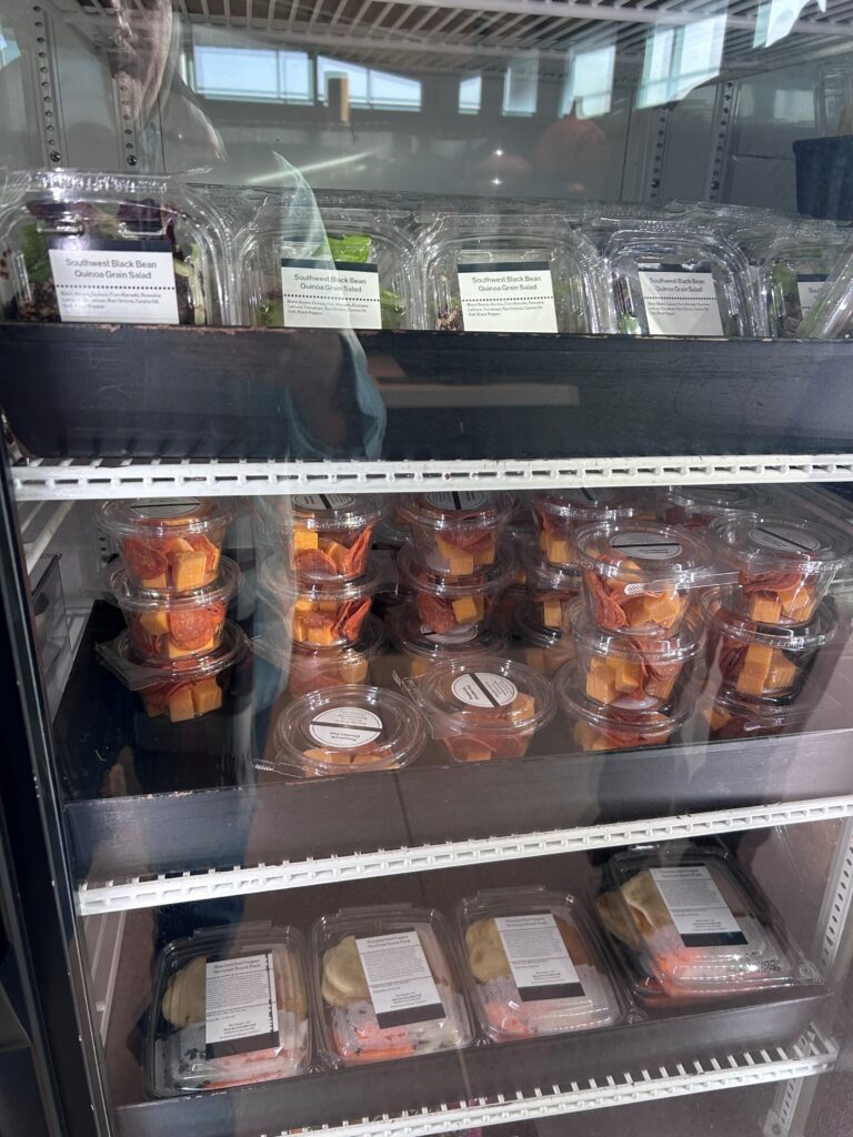 a refrigerator with plastic containers of food