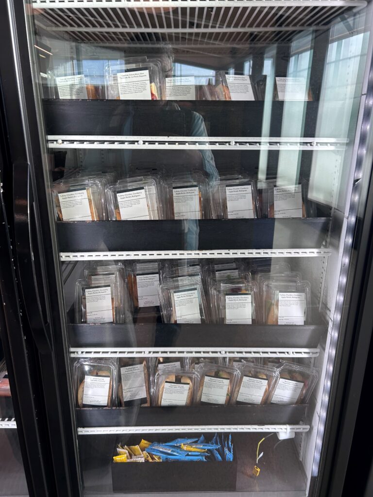 a refrigerator with plastic containers of food