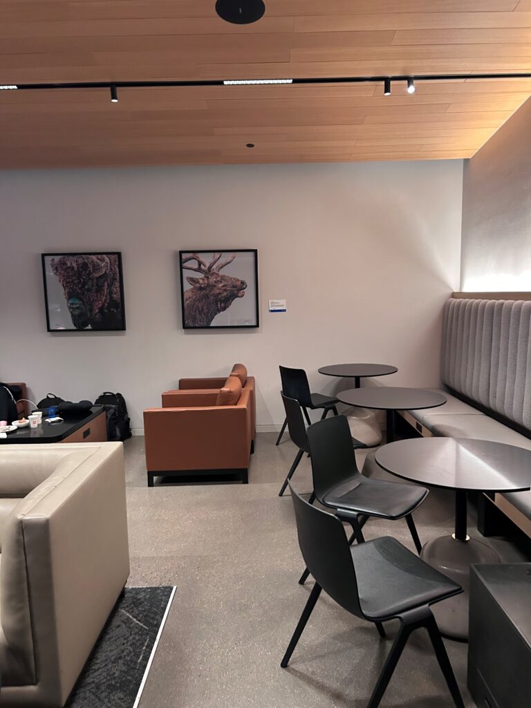 a room with a couch and tables and chairs