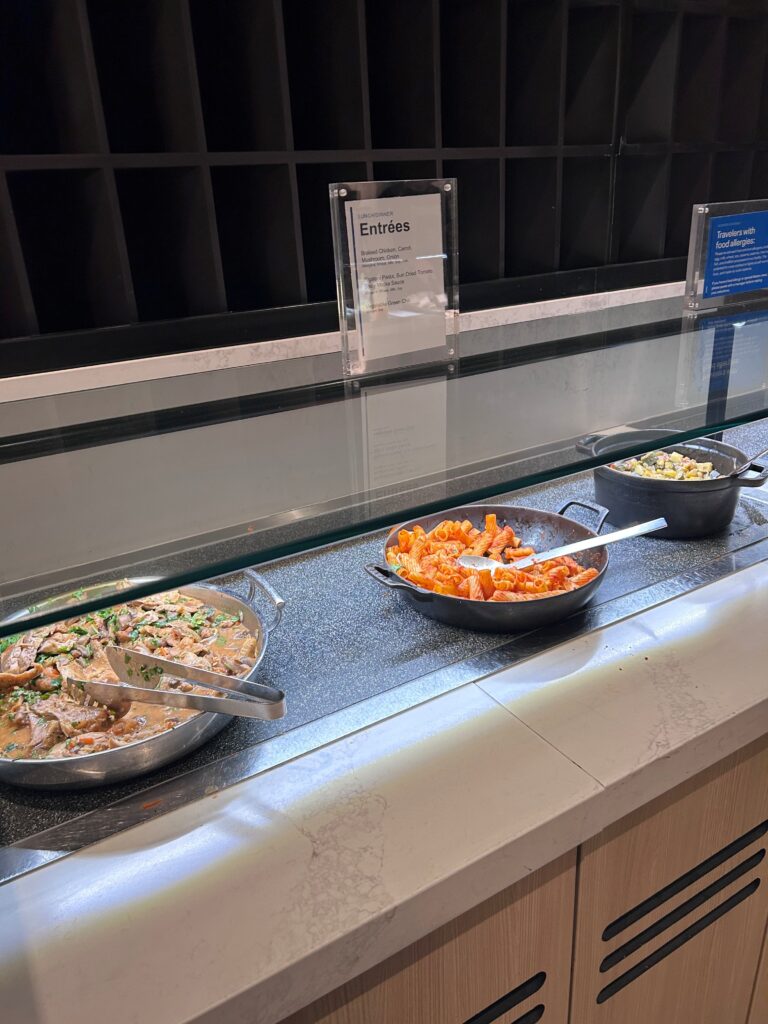 a row of bowls of food on a counter