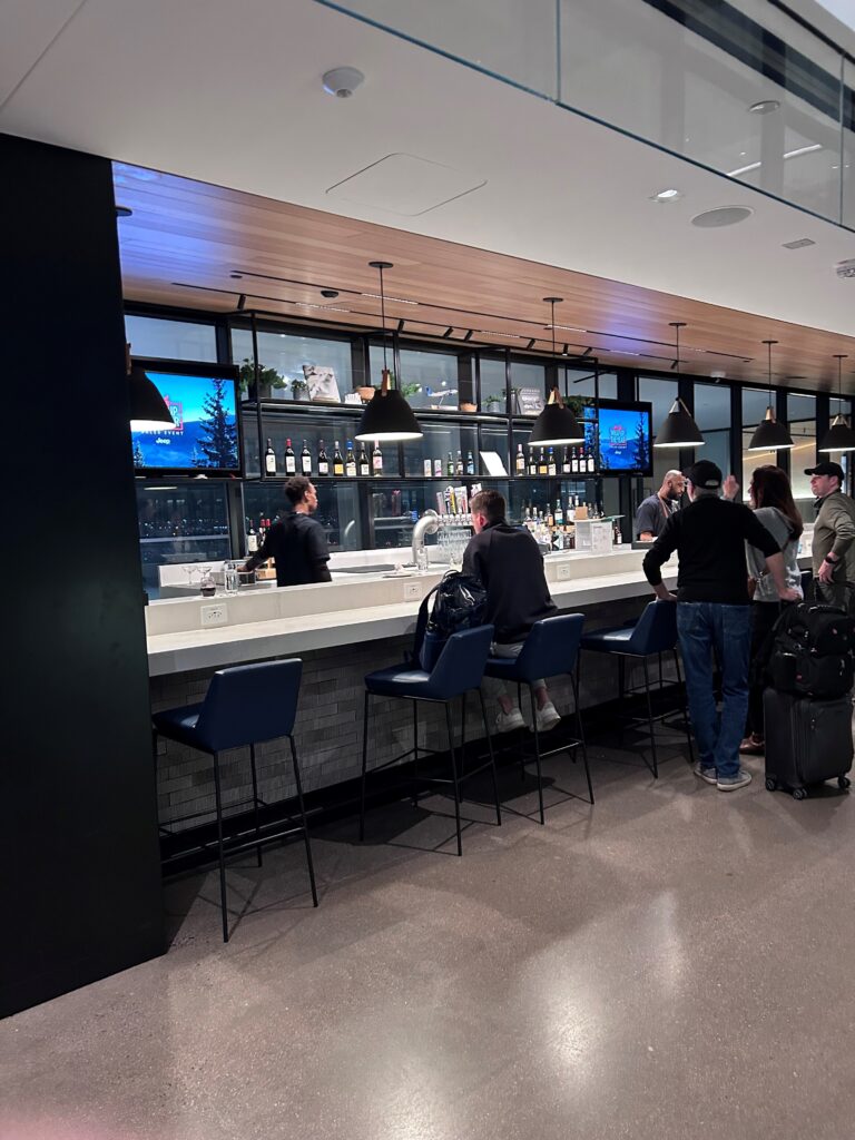 people standing in a line at a bar