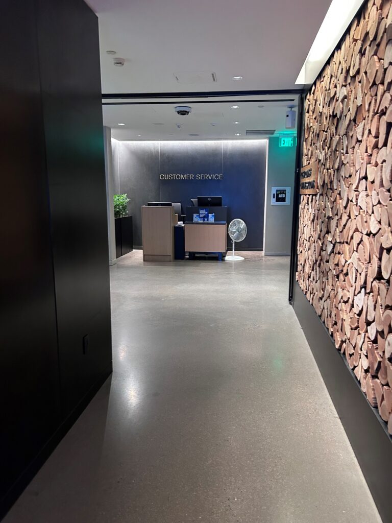 a hallway with a reception desk and a fan
