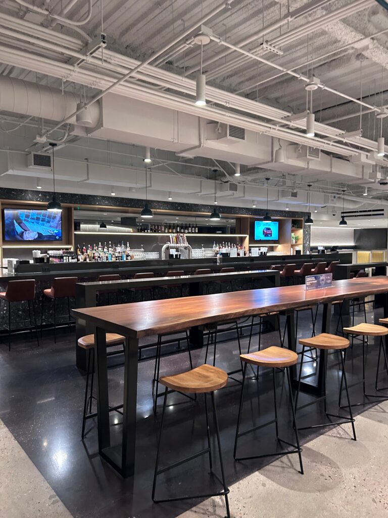 a bar with a long table and chairs