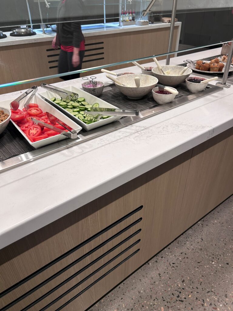 a buffet line with food in bowls