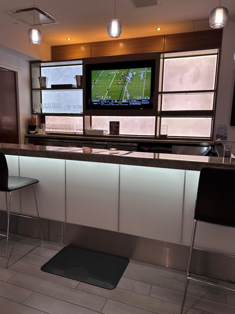a bar with a television and shelves
