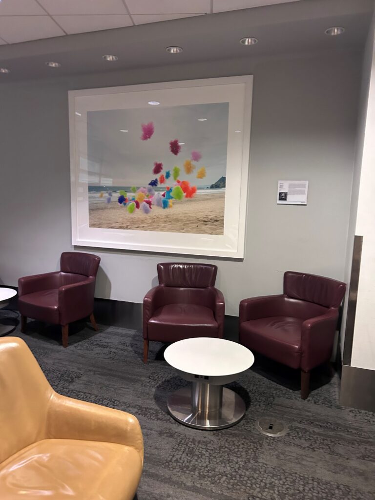 a group of chairs and a painting on the wall