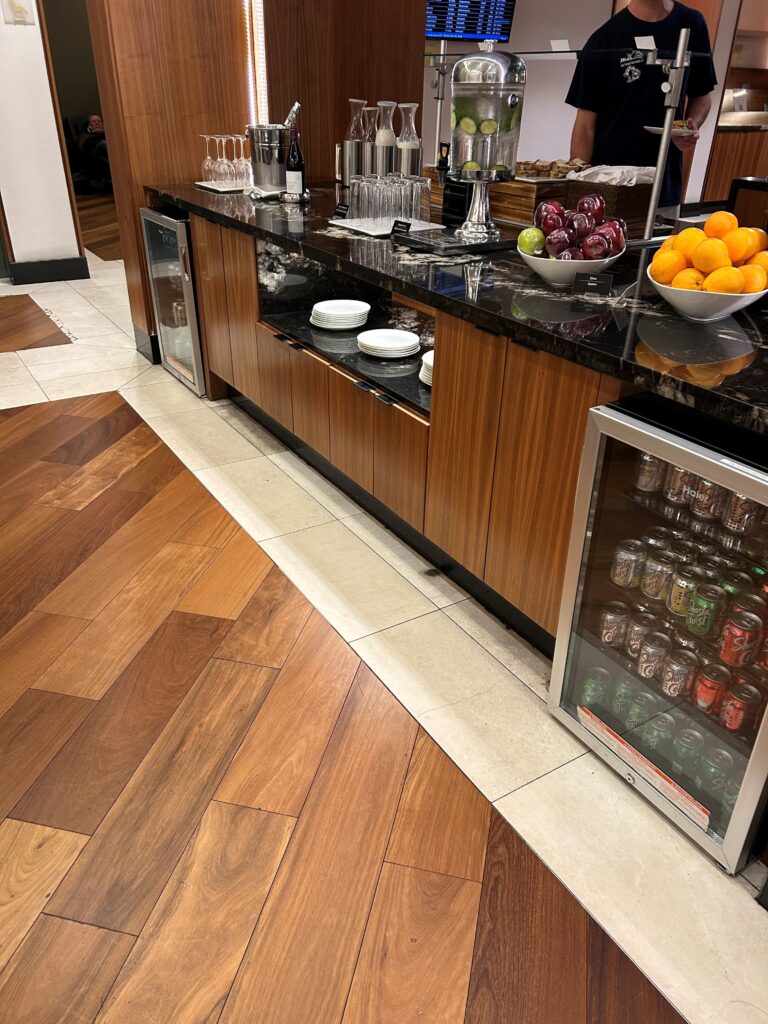 a counter with fruit and drinks on it