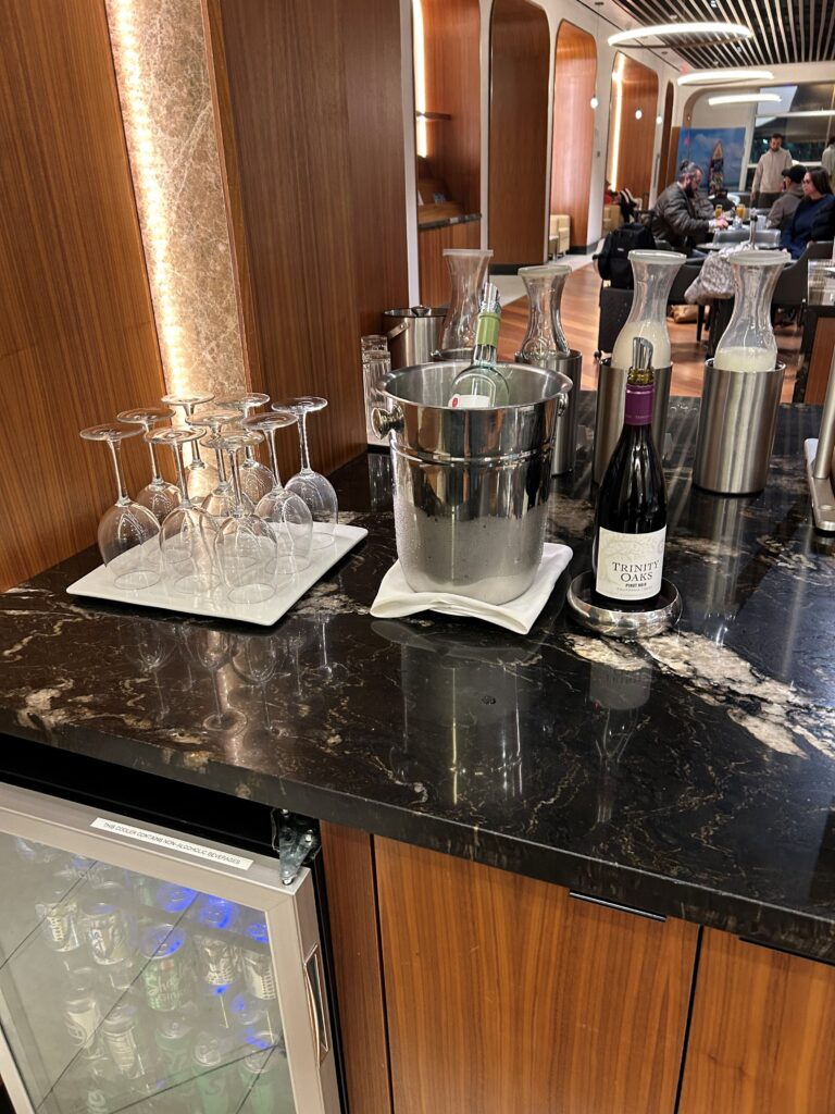 a bar with wine glasses and bottles