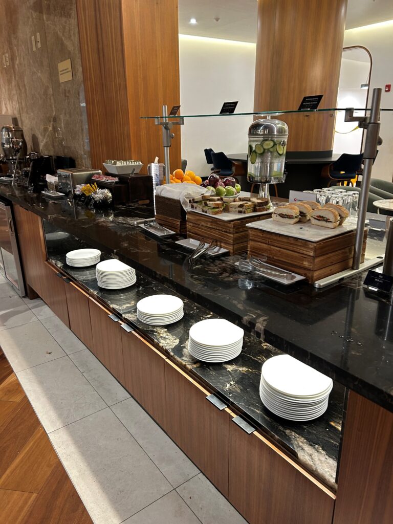 a buffet with plates and sandwiches