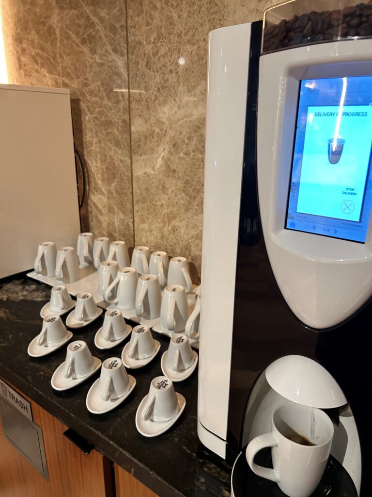 a coffee machine with cups on it
