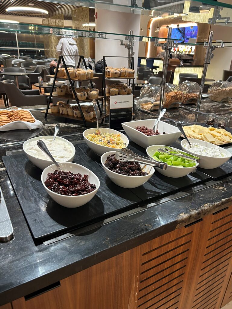 a buffet table with bowls of food