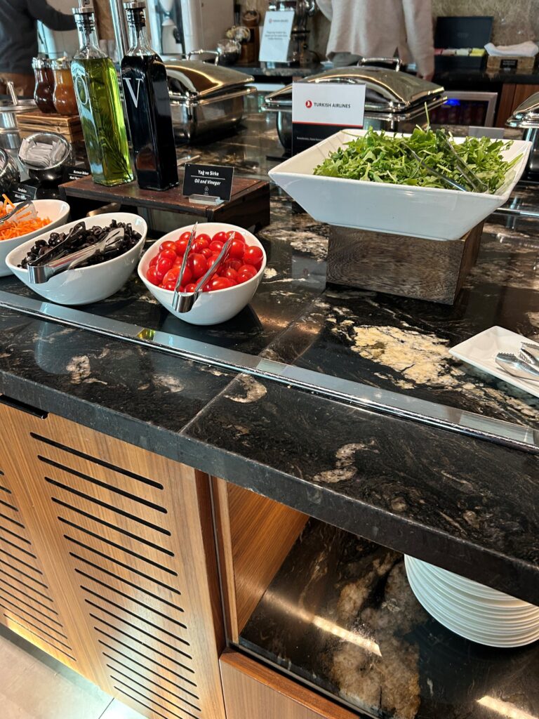 a buffet line with salads and vegetables