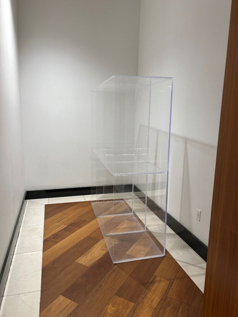 a clear display case on a wood floor
