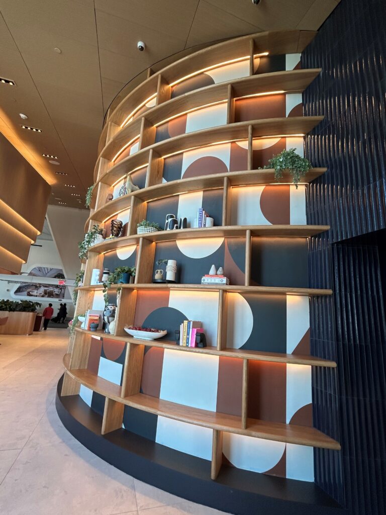 a wall with shelves and plants on it