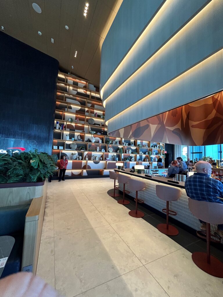 a room with a wall of shelves and a bar